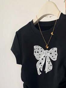 Camiseta de manga corta con lazo grande y estampado para niñas preadolescentes, versátil y casual