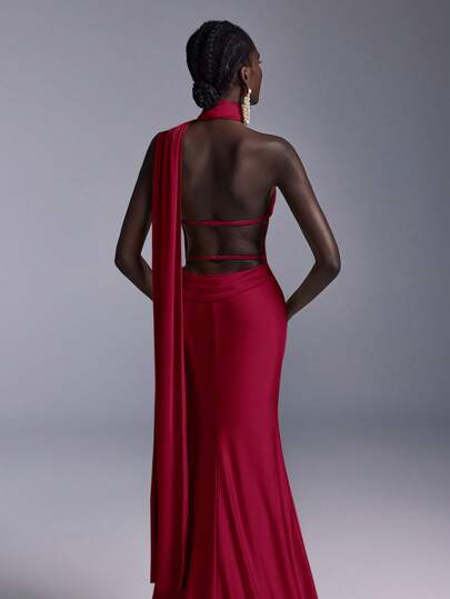 Elitara Elegant, Glamorous, And Stylish Burgundy Knit Fabric Gown With A Deep Backless Design, Flowing Ribbon Neckline, Fitted Mermaid Silhouette, And Long Train. Suitable For Formal Occasions Such As Weddings, Cocktail Parties, Balls, And Elaborate Evening Gowns.