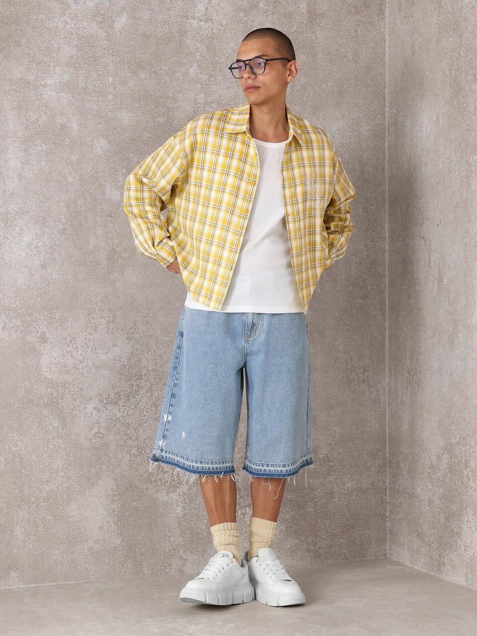 SUMWON Chemise décontractée oversize à manches longues avec boutons et motif à carreaux. Design classique essentiel pour les couches en mode automne-hiver streetwear contemporaine
