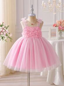 SHEIN Baby Girls' Spaghetti Strap 3D Bow Floral Tulle Party Dress. The Bow And Floral Patterns Complement Each Other, Adding A Touch Of Playfulness And Cuteness. The Puffy Silhouette Design Makes The Dress More Voluminous And Suitable For Children's Parties, Birthday Celebrations, And Other Formal Occasions, Showcasing The Elegant Charm Of A Little Princess. Let Your Baby Be The Center Of Attention Everywhere. - Pink - View 1