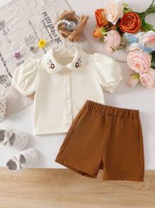 SHEIN Vintaside Kids Bộ 2 món áo sơ mi ngắn tay cài cúc cổ bẻ in hoa và quần short cạp chun cho bé gái, trang phục thường ngày dễ thương cho mùa xuân/hè/thu. - màu nâu - Xem 2