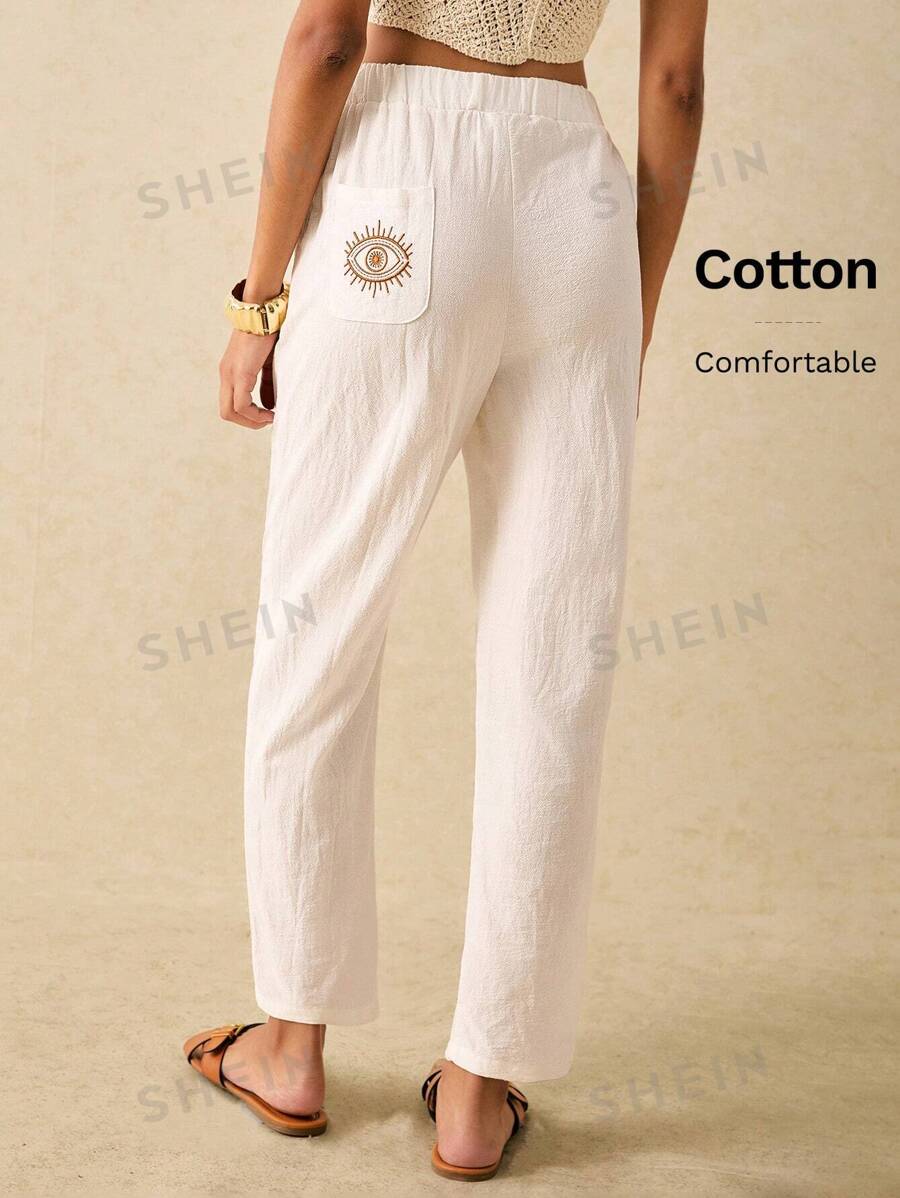 Poéselle Pantalones largos sencillos y básicos para mujer con bordado de patrón de ojo, pantalones blancos de verano, pantalones tipo zanahoria, un esencial chic sin esfuerzo