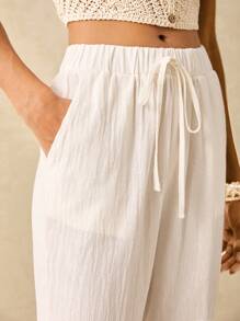 Poéselle Pantalones largos sencillos y básicos para mujer con bordado de patrón de ojo, pantalones blancos de verano, pantalones tipo zanahoria, un esencial chic sin esfuerzo