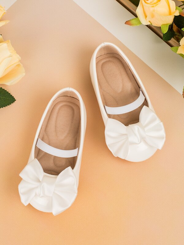 1 paire de chaussures bébé plates, design nœud mignon en PU + coussin de massage, semelle souple antidérapante, convient pour le printemps, l'été, l'automne et l'hiver