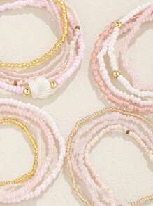 Conjunto de 17 brazalete apilable estilo bohemio con cuentas de vidrio y semillas en tono rosa para mujeres
