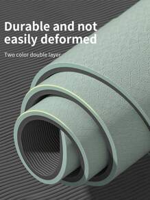 1塊183*57*0.6公分的綠色瑜伽墊,由tpe材料製成,帶有定位線和護帶,適用於瑜伽和普拉提等運動