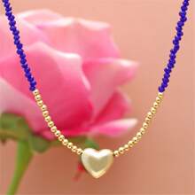 1條女性用精緻時尚的珊瑚粉色長頸鍊。它採用細金色鍊條,上面串著幾何多切割水晶珠,小心形吊飾和閃亮光澤。非常適合情人節、蜜月、度假或旅行等場合。 - 桃色 - 查看 5