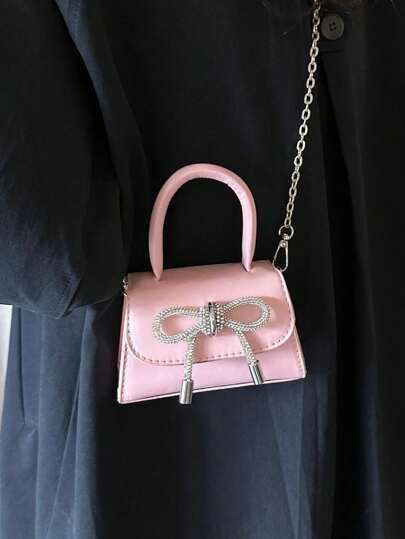 1入兒童純色pu手提包,配有蝴蝶結細節,簡約時尚,可作為手提包或斜挎包使用