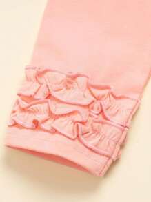 Conjunto de top de manga corta con dobladillo de encaje rosa y pantalón largo