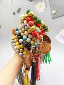 1入女士條紋木珠鑰匙扣,附有“mama”字母刻印的木片吊飾流蘇手環鑰匙扣,可用於包包配飾珠寶掛件,是給媽媽的完美禮物。 - 條紋 - 查看 12