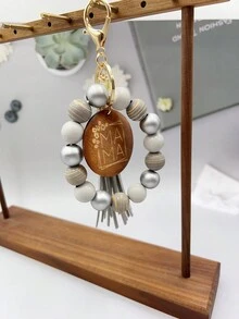 1入女士條紋木珠鑰匙扣,附有“mama”字母刻印的木片吊飾流蘇手環鑰匙扣,可用於包包配飾珠寶掛件,是給媽媽的完美禮物。 - 條紋 - 查看 17