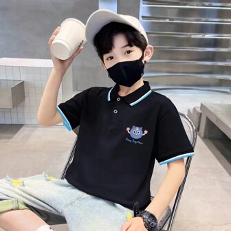 1件青少年男孩彩色拼接卡通印花短袖Polo衫，適合春夏休閒運動風格