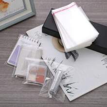 100 piezas Bolsas de empaque OPP transparentes, para empacar libros, decoraciones, papelería, regalos, abarrotes, etc. Bolsas a prueba de polvo y humedad, vuelta a la escuela Día de San Valentín