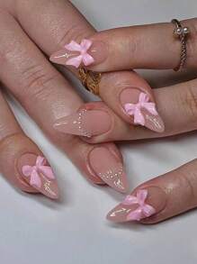 24 pièces/set Ongles pressés longs d'amande rose avec nœud papillon et fausse perle, un design doux et d'ongles fausses. Contient 1 pièce de colle gelée et 1 pièce de lime à ongles, convient pour un usage quotidien au travail et lors de fêtes, fournitures d'ongles pour femmes et filles