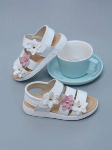 Nuovi sandali classici alla romana per bebè e ragazze, con fiore a sei petali in rilievo, disponibili in 3 colori, suola morbida antiscivolo con chiusura a strappo facile, sandali da principessa in pelle per prescolari. Nota: il motivo laterale sulla suola può variare leggermente tra le taglie [21-25, 26-29]