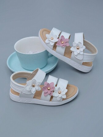 Nuevas sandalias romanas clásicas de 3 colores, con diseño de flor de seis pétalos en relieve, para bebés y niñas. Suela suave antideslizante con cierre de gancho y bucle fácil. Sandalias de princesa para preescolar. Nota: El diseño lateral de las suelas puede variar ligeramente entre los rangos de talla [21-25, 26-29]