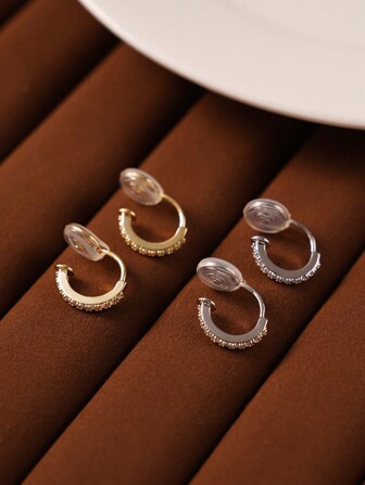 Un par de pendientes redondos de cobre delicados y simples con plateado, decorados artificialmente, sin perforaciones para mujeres que usar diariamente.