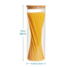 A Large Plastic Food Storage Container With A Sealed Wooden Lid, Used For Storing Pasta, Nuts, Flour. Ideal For Kitchen Organization And Storage In A Pantry With Glass Jars.