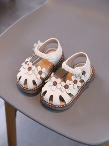 1 paire de sandales classiques pour enfants avec ornement floral, style buttercup, design crochet et boucle en PU antidérapant. Chaussures de princesse mignonnes pour bébés, convenant pour le printemps, l'été, l'automne et l'hiver