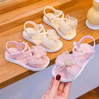 Sandal hở mũi đính nơ đính đá dễ thương, thoáng khí, thích hợp cho kỳ nghỉ biển của bé gái.