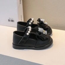 1 Par de sapatos planos pretos para bebês meninas em cor sólida com fechamento de gancho e laço e laço bonitinho, adequado para primavera e outono
