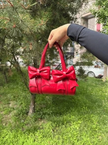 حقيبة يد دائرية خفيفة ومميزة بتصميم صيفي أحمر بالعقدة الزخرفية، مناسبة للفتيات الصغيرات للسفر والحفلات