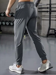 Pantaloni sportivi con vita elastica, coulisse e tasche con cerniera, in tinta unita, adatti per esercizio, fitness, escursionismo, corsa e uso casual