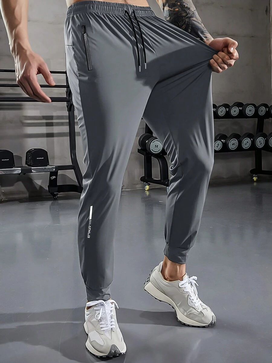 Pantaloni sportivi con vita elastica, coulisse e tasche con cerniera, in tinta unita, adatti per esercizio, fitness, escursionismo, corsa e uso casual
