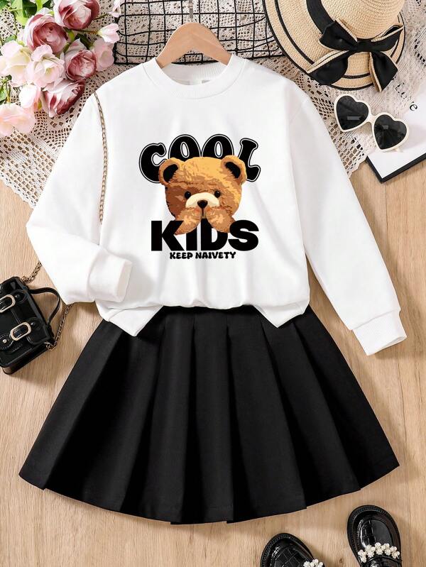 Conjunto de niña preadolescente con camiseta de manga larga de cuello redondo estampada de dibujos animados y falda plisada sólida