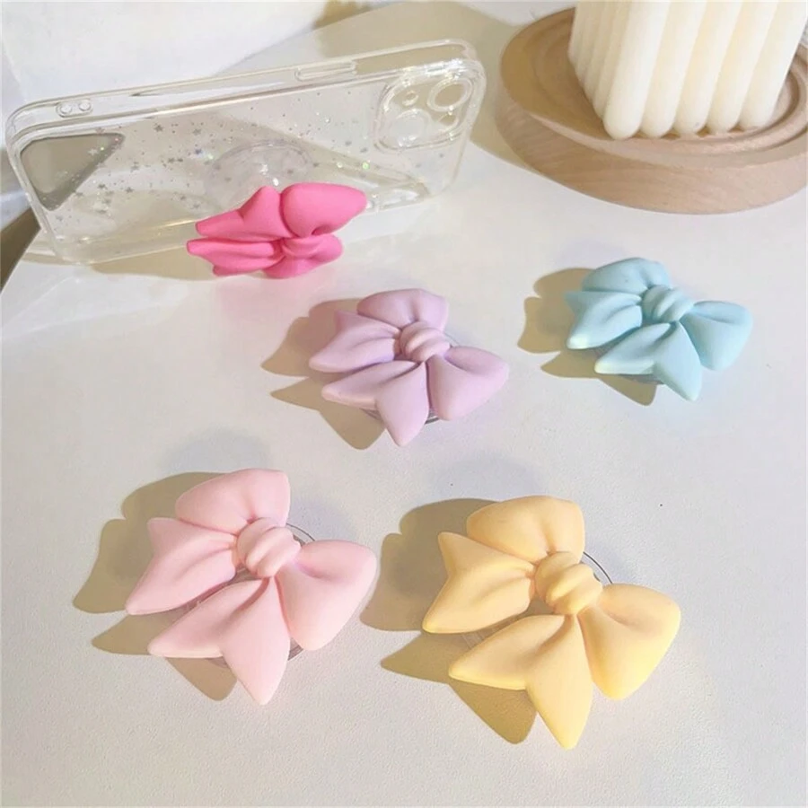 采用 ABS 材质的马卡龙蝴蝶结手机支架，防水，适用于智能手机的多功能支架，彩色哑光桌面支架