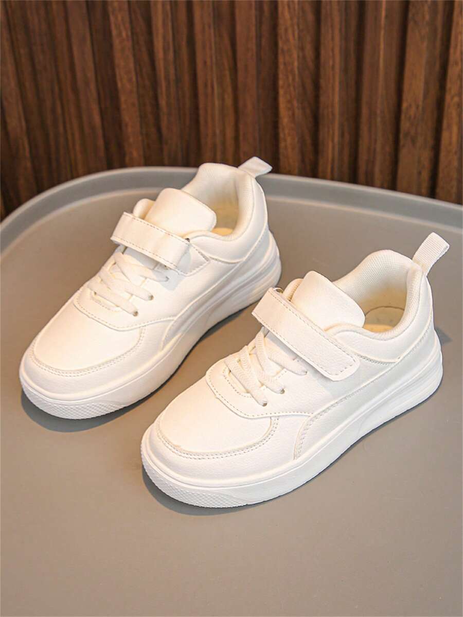 Ein Paar klassischer Unisex weißer Sneakers mit Klettverschluss Design, weiche Sohle, geeignet für Frühling und Herbst