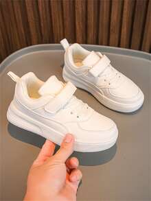 Ein Paar klassischer Unisex weißer Sneakers mit Klettverschluss Design, weiche Sohle, geeignet für Frühling und Herbst