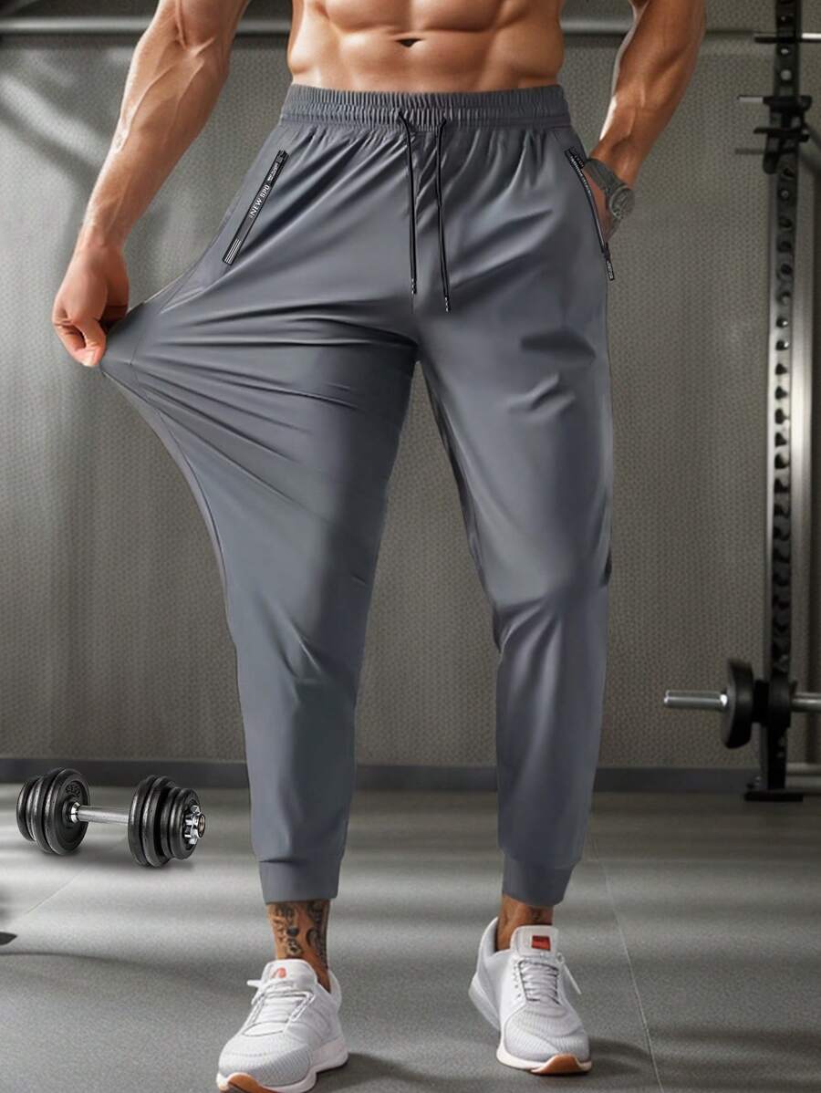 Pantalones de sudadera casuales y cómodos de verano para hombres con bolsillo con cremallera, cintura ajustable y detalles reflectantes, para entrenamiento
