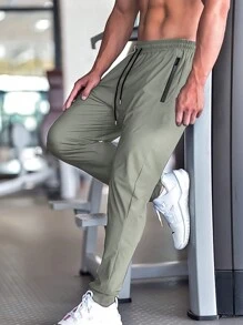 Pantalon de jogging casual d'été pour hommes, avec poches zippées, taille ajustable et détail réfléchissant. Confortable et extensible.