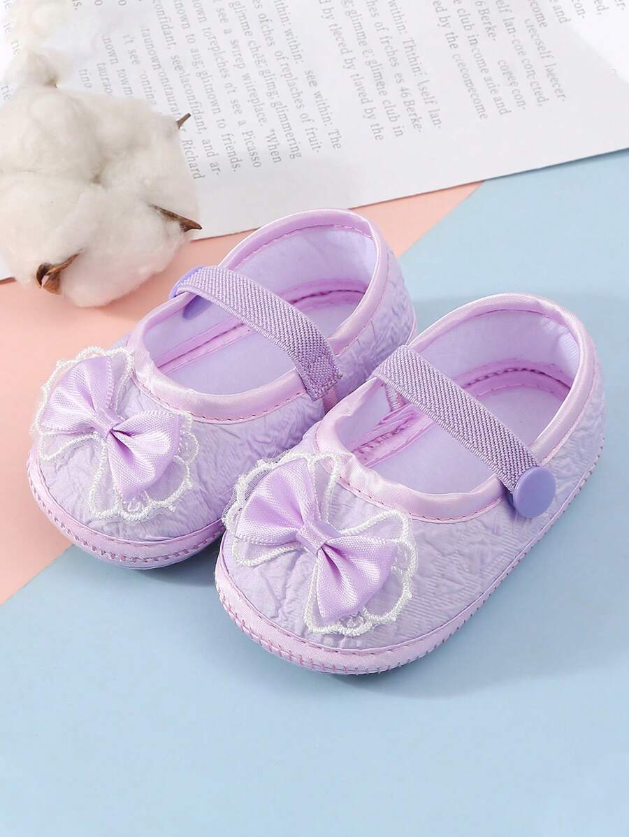 1 đôi giày trẻ sơ sinh chống trượt thích hợp cho trẻ mới biết đi trong nhà, giày đế bằng mềm mại có thiết kế nơ dễ thương. - Màu tím - Xem 1