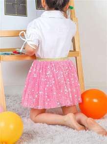 Falda mini decorativa para niña joven con malla brillante y decoración con lentejuelas