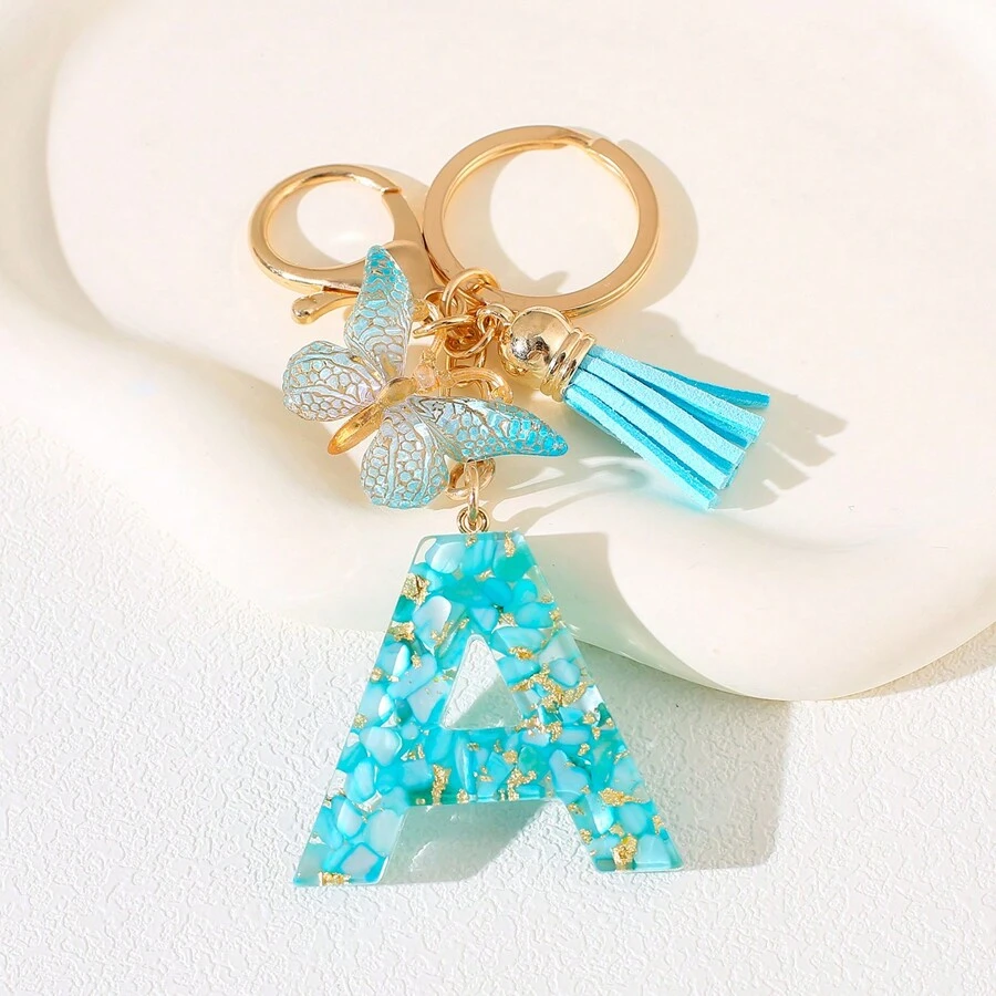 Llavero con letra del alfabeto en azul cielo con flecos de mariposa, llavero con inicial de piedra de resina con mosquetón - Accesorio decorativo de llavero para mujer, niña, mochila, colgante, accesorios para bolso, cordones con portaidentificación, accesorios para coche, encantos para bolso, regalo de Navidad, regalo para maestra, amiga, hermana
