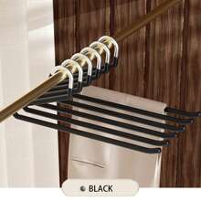 现代简约黑色和米色天鹅形裤子衣架，带防滑涂层，用于整理衣物