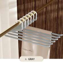 现代简约黑色和米色天鹅形裤子衣架，带防滑涂层，用于整理衣物