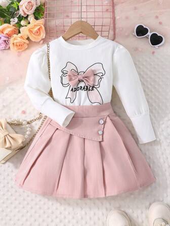 年轻女孩春秋长袖圆领蝴蝶结印花 T 恤和纯色纽扣装饰短褶裙 2 件套休闲装