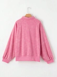 Sweatshirt à manches tombantes avec demi-boutons, nœud papillon et séquins