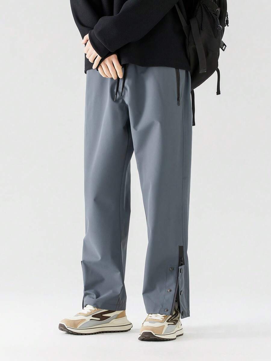 男士轻便透气速干运动裤，灰色修身弹力裤，带拉链口袋和可调节裤脚，适合户外活动、健身和跑步