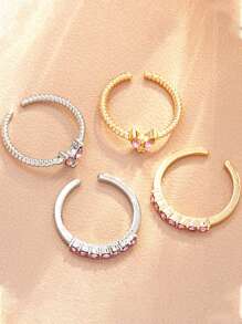 Set de 4 anillos ajustables con diseño de mariposa y corazón de cristal en tonos dorado y plateado, joyería para niña