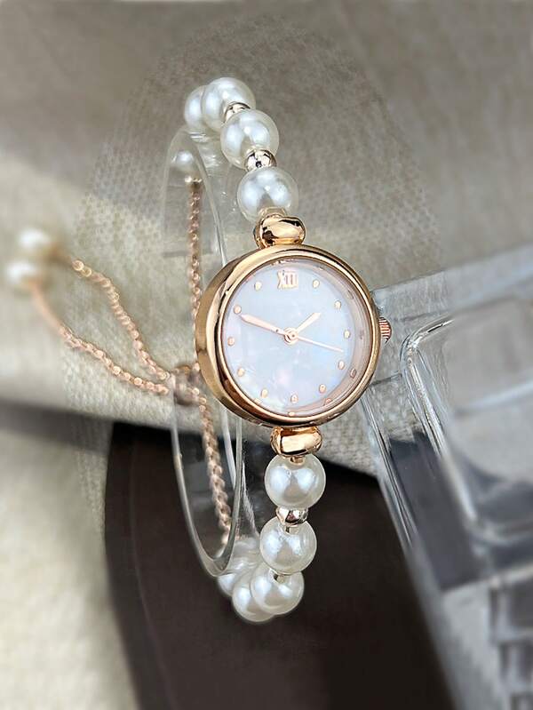 قطعة واحدة ساعة نسائية من الألوان الفضي والذهبي لؤلؤة بسوار مطاطي، إطار ياقوتي النص لنبيلة وعقارب من اللؤلؤ الأم بشقوق قرط موصوف للاحتفالات أو هدية لطلاب العودة للمدرسة