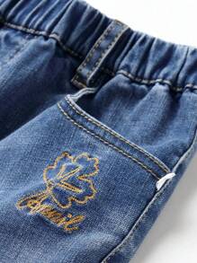 Annil Jeansy dla dzieci Tween Girl. Spodnie jeansowe z haftem w słodkie kwiaty i pełną talią. Jesienne proste i swobodne jeansy z włókien roślinnych