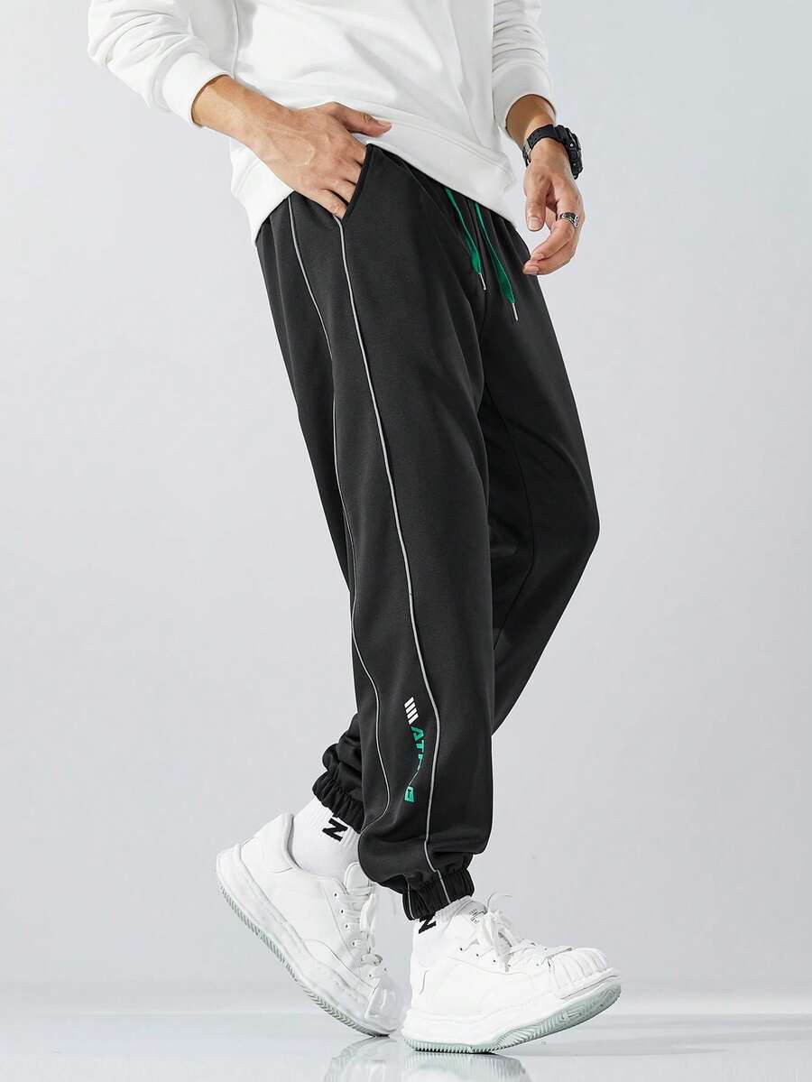 1 quần dài thường ngày dày dặn có dải phản quang cho nam, quần nỉ buộc mắt cá chân dáng rộng cho mùa thu/đông - màu đen - Xem 1