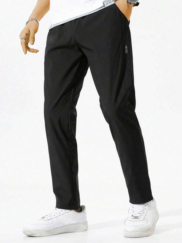 Pantalones largos de hombre con bolsillos con cremallera y cordón ajustable en la cintura