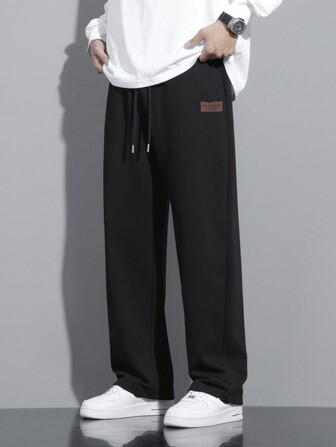 男款字母拼接束口褲