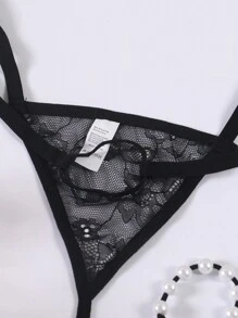Tanga transparente y erótico de hombre con forma de O, de perlas y encaje calado de talle bajo