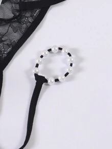 Tanga transparente y erótico de hombre con forma de O, de perlas y encaje calado de talle bajo
